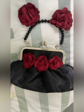 Black Satin Clutch with Burgundy Rose Accents and a pair of rose earrings.